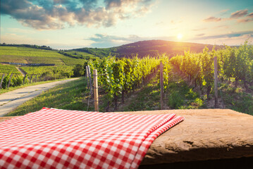 Barrel Wineglasses Cheese And Bottle In Vineyard At Sunset . High quality photo
