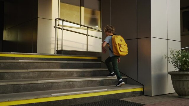 Little Schoolboy Walking Up Over Stair Of School Building, Back To School, New Educational Year