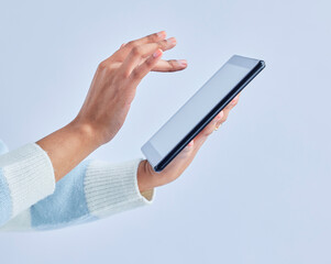 Hands, tablet and person on studio for social media, reading ebook and search website on gray background. Closeup, model and digital technology for connection, download and scroll online shopping app