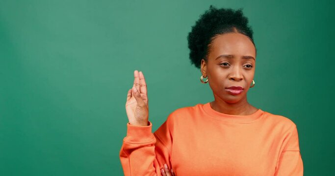 Disapproving young Black woman makes talk to the hand gesture, attitude, studio