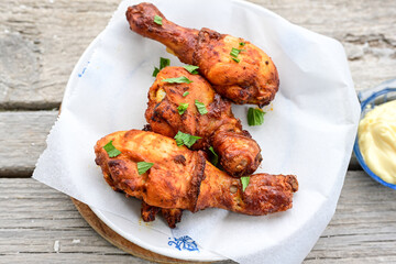 Crispy  deep fried home made    chicken   legs  Breaded  with  almond flour chicken  breast fillets  with chilly peppers and fresh   basil on wooden rustic background. Ketogenic diet food