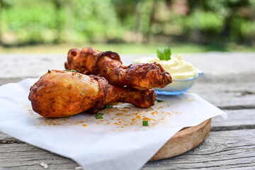 Crispy  deep fried home made    chicken   legs  Breaded  with  almond flour chicken  breast fillets  with chilly peppers and fresh   basil on wooden rustic background. Ketogenic diet food