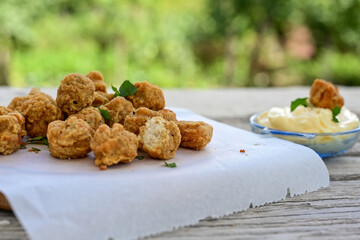 Crispy  deep fried   chicken  nuggets . Breaded  with Cornflakes Breast fillets  with chilly peppers and fresh   basil on wooden rustic background