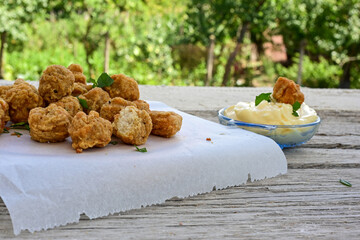 Crispy  deep fried   chicken  nuggets . Breaded  with Cornflakes Breast fillets  with chilly peppers and fresh   basil on wooden rustic background