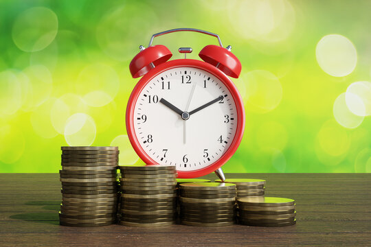 Alarm clock behind stacks of coins on wooden table with green bokeh background. Illustration of the concept of time value of money