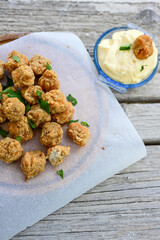 Crispy  deep fried   chicken  nuggets . Breaded  with Cornflakes Breast fillets  with chilly peppers and fresh   basil on wooden rustic background