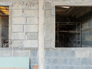 The block wall is under construction and unplastered.