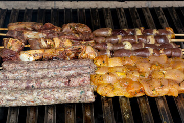 grilling meat skewer, traditional brazilian barbecue with meat on skewer known as espetinh or churrasquinho