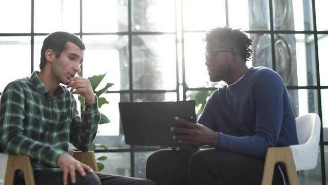 Middle age businessman interviewing potential employee in waiting room