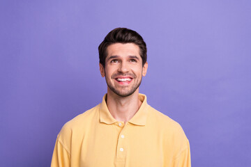 Photo of dreamy funky man dressed yellow shirt looking up empty space isolated purple color background