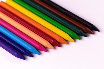 High angle closeup shot of colorful crayons on white background -Play school concept.