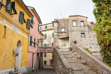 a street that goes up to the tower of San Francesco in Sarzana, Province of La Spezia, Liguria, Italy - obrazy, fototapety, plakaty