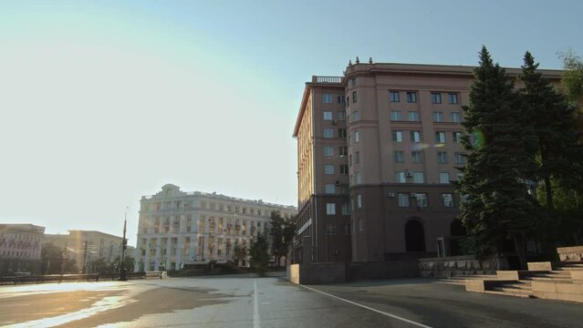 No people establishing shot of empty central city street with classic style buildings on sunny summer morning with wet road after rainNo people establishing shot of empty central city street with clas