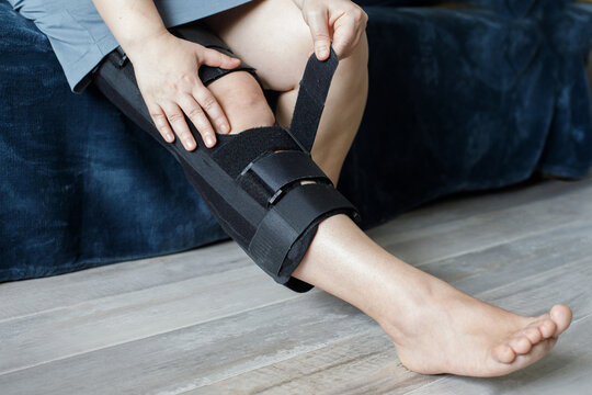 Knee Support Brace on leg. Orthopedic Anatomic Orthosis. Braces for knee fixation, injuries and pain. Orthotics. Foot orthosis tutor