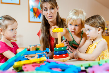 Children in nursery school learning and playing games