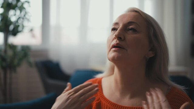 Middle-aged woman heavily sweating, suffering from hot flash, menopause symptom