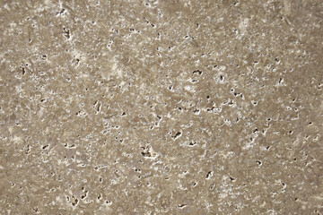 Background of brown polished stone texture with abstract pattern, for design, uneven surface, full frame. Copy space. Selective focus.