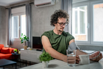 Fototapeta na wymiar one adult caucasian man measure check blood pressure at home alone