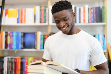 A young student in a library, deeply engrossed in learning, wears a joyful smile.