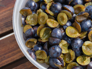 Sliced blackthorns in plastic bowl