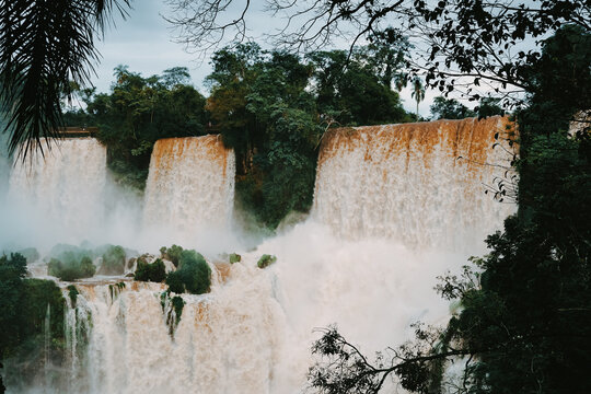 Majestic view of many cascades of water flowing under cloudy blue sky