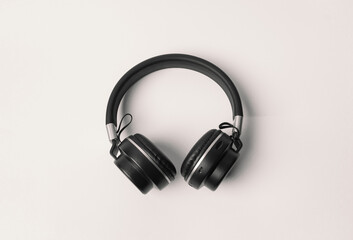 Fototapeta na wymiar Black headphones, wireless headphones on a minimalist white background