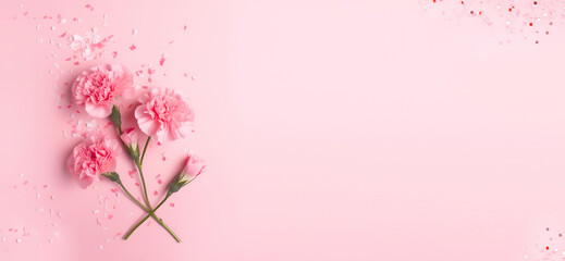 Obraz premium Creative Floral composition. Pink carnation flowers with confetti and petals on pastel background. Template for product presentation display. flat lay top view. copy text space banner