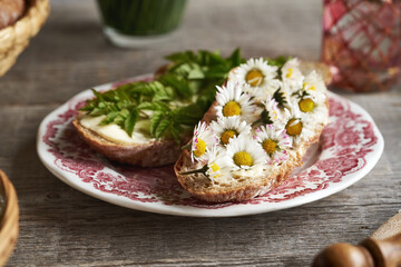 Lawn daisy and ground elder on slices of bread