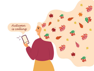 A young girl holds a mobile phone with the inscription Autumn is ringing. Autumn concept.