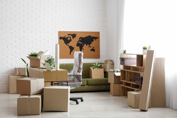 Modern workplace with cardboard boxes in office on moving day