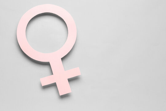 Paper symbol of female on grey background