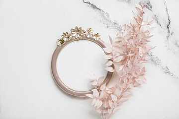 Mirror with dried plant on white grunge background