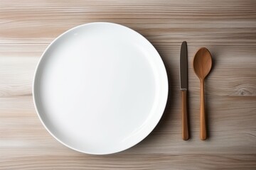 White plate and fork with knife, top view