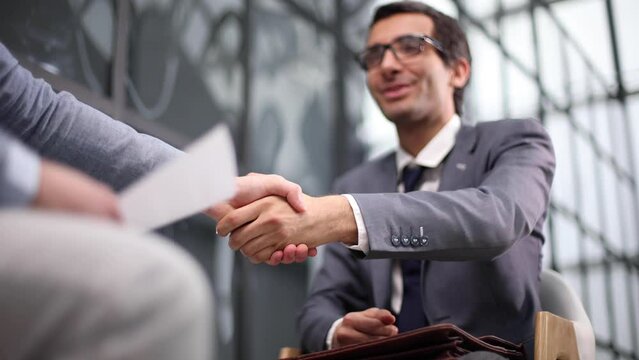 Shot of businessmen making a deal after viewing a document