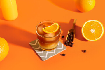 Glass of tasty orange espresso on color background