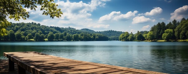 Fototapeta na wymiar Wooden deck at lake under blue sky