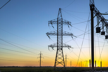 High voltage pylons in the morning during sunset.