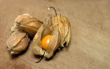 Fresh Aguaimanto fruit from Peru, with still in its leaves on a wooden table.