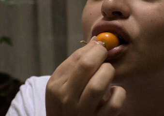 Woman eating Aguaimanto fruit from Peru