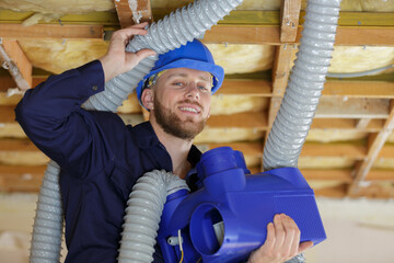 male worker and air duct installation