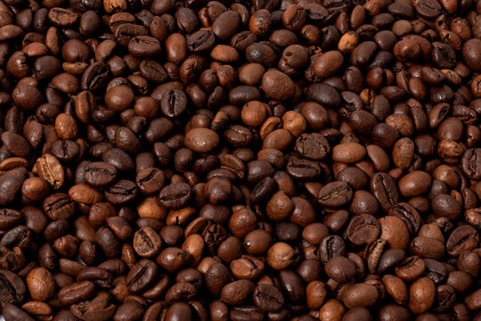 whole roasted coffee beans in close-up as a background image