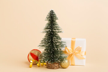 Miniature christmas tree with gift boxes and decor on table