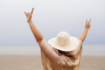 Joyful tourist on summer vacations on the beach