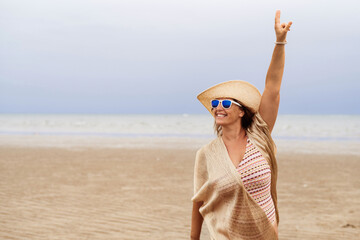 Joyful tourist on summer vacations on the beach