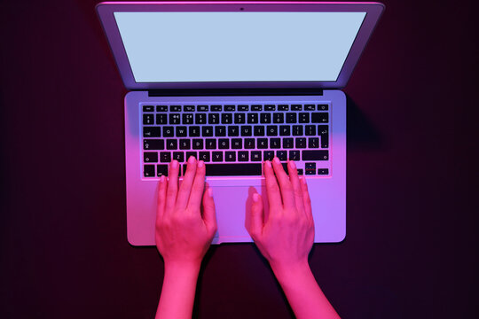 Woman working with modern laptop on black background - Powered by Adobe