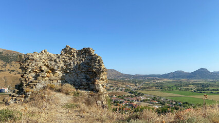 Fototapeta na wymiar Ancient ruined Kalekoy castle (Genoa Castle) and Bademli plain from Gokceada in northern Aegean of Turkey. Imbros island, Canakkale, Turkey