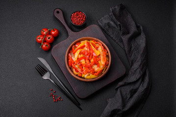 Delicious fresh saute sweet bell pepper slices with onion, salt, spices and herbs