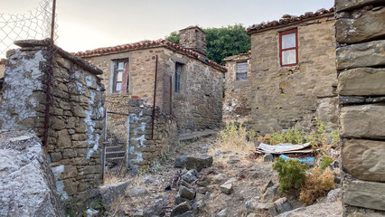 Fototapeta na wymiar Ruined houses in Greek village of Tepeköy (Agridia), one of the most touristic places of Gökçeada - Turkish Aegean Island Gökçeada. Canakkale