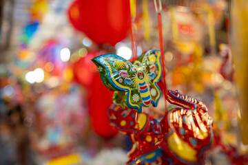 Decorated colorful lanterns hanging on a stand in the streets in Ho Chi Minh City, Vietnam during Mid Autumn Festival. Chinese language in photos mean money and happiness