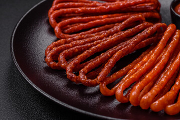 Delicious thin smoked hunting sausages with salt, spices and herbs